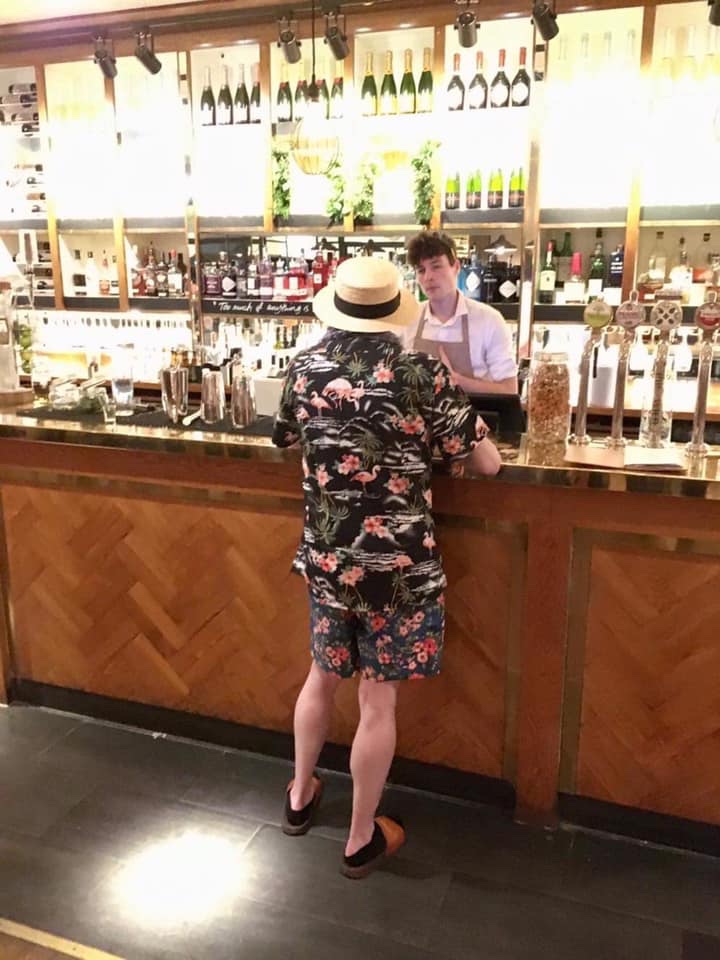 Alex in a silly outfit at the bar